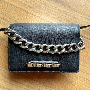 Alexander McQueen Four-ring black leather mini Crossbody Bag.